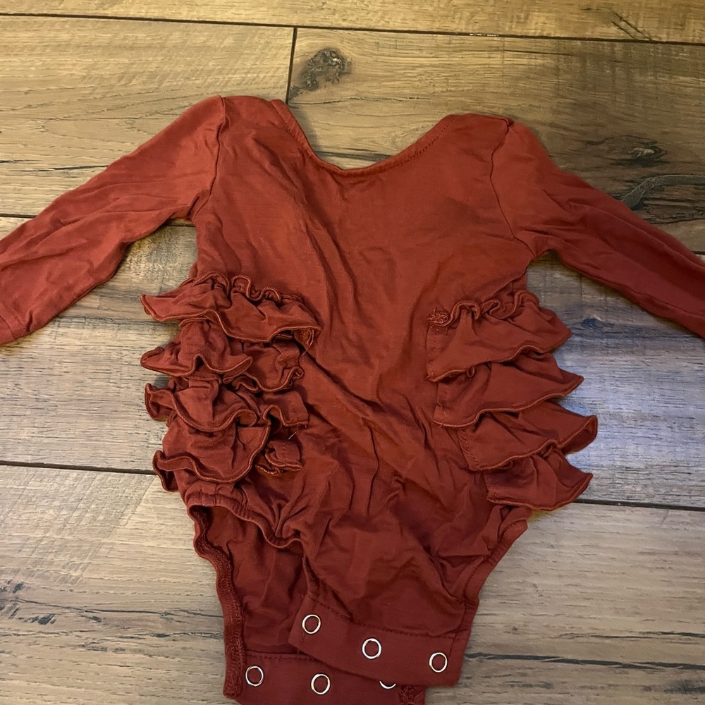 Rust color Kate Quinn ruffle leg onesie
